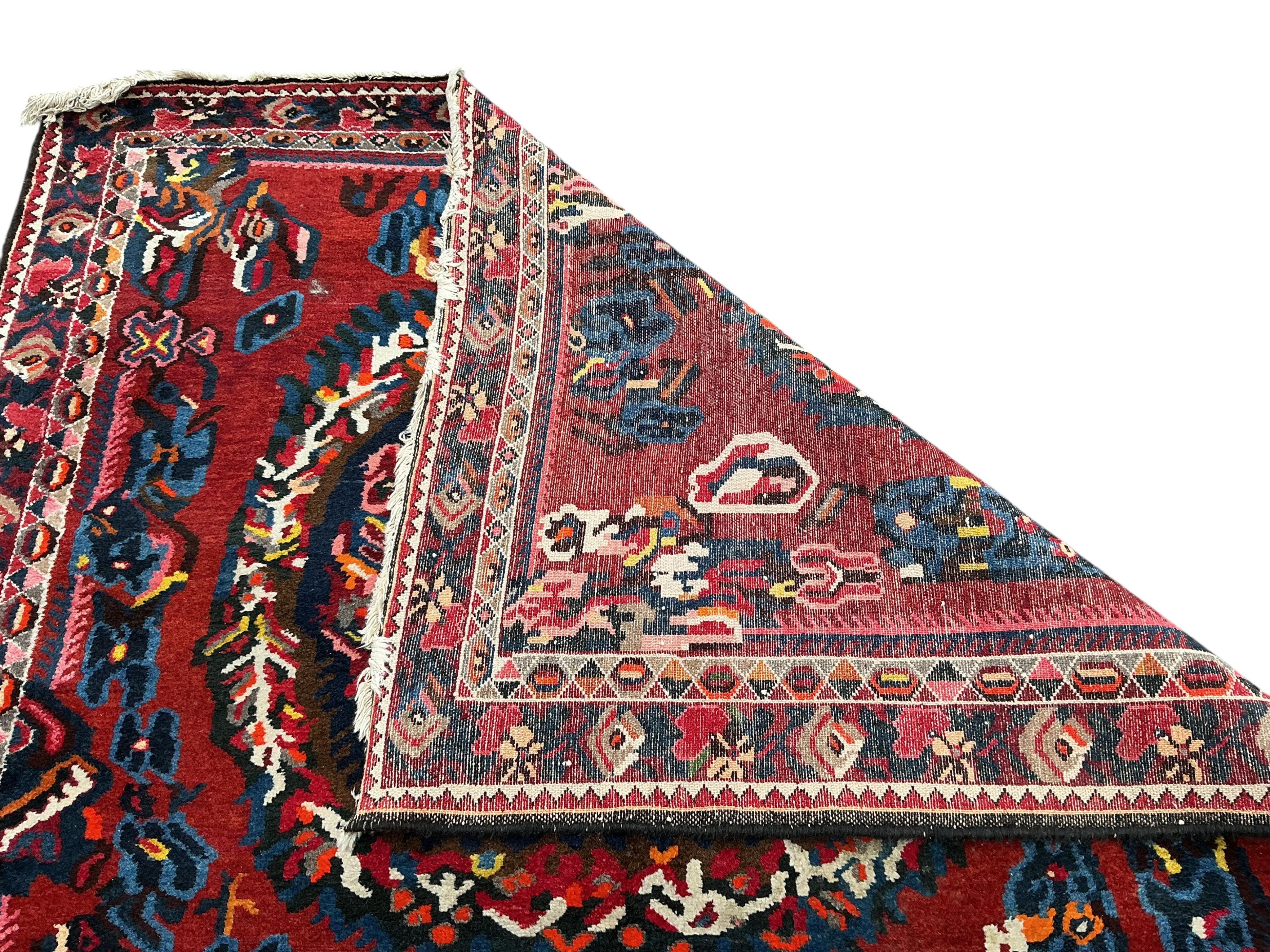 A Baktiari red ground carpet, 390 x 170cm
